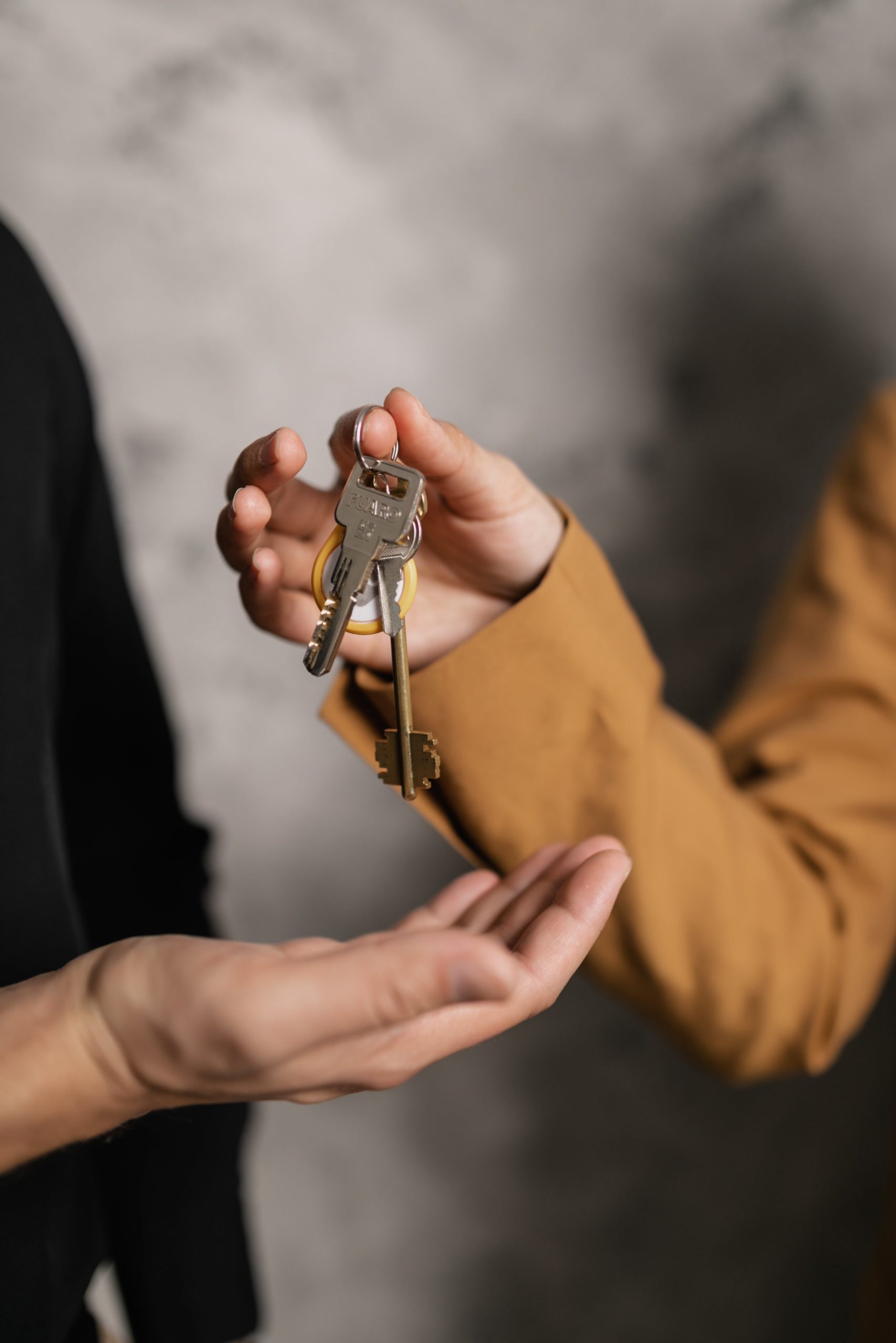 property manager owner client handing keys to manager